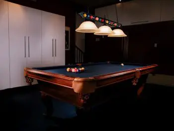 pool table with some pool lights above