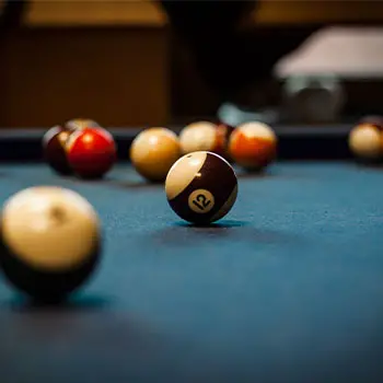 blue pool table and billiard balls